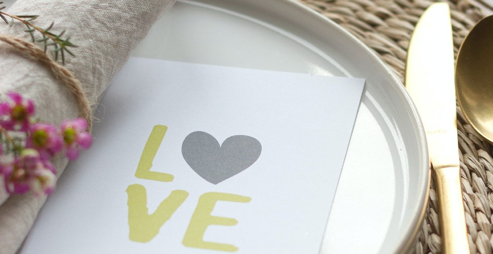 Valentine's Day dinner place setting with a napkin saying 'love'